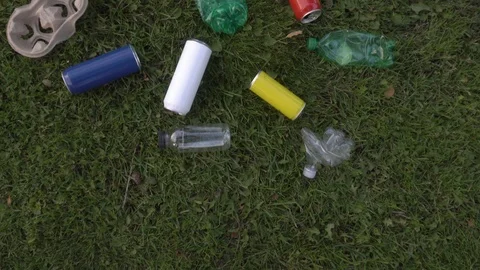 Used bottles and trash scattered around the lawn Stock Footage 120090220
