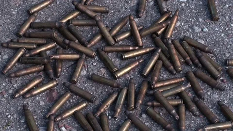 Used bullet shells falls on the ground Stock Footage 80252111