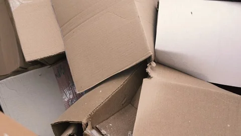 Used cardboard boxes lie in a heap. Close-up. Waste sorting. Recycling Stock Footage 122759645