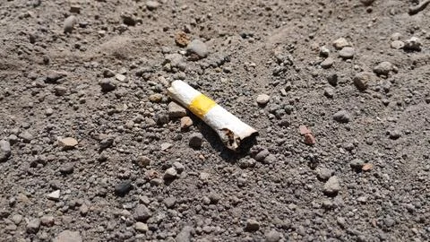 Used Cigarette Butt On Sand Stock Photos