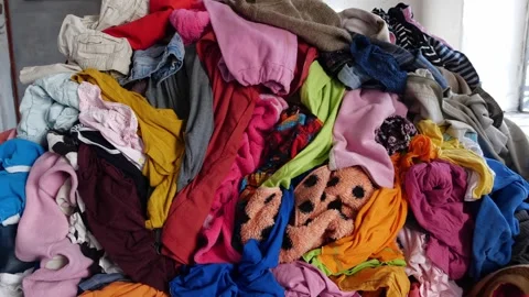Used clothes. A big pile of old unnecessary clothes. Fast fashion, garbage and 库存影片 293853610