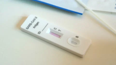 Used coronavirus atk test without stripes on white table at home, waiting result Stock Footage 186018257