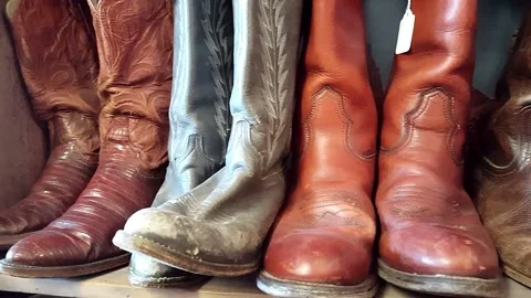 Used Cowboy Boots on a Shop Shelf, Panning Shot Stock Footage