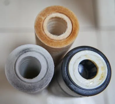 Used dirty replaceable filter cartridges for drinking water purification. Wat Stock Photos