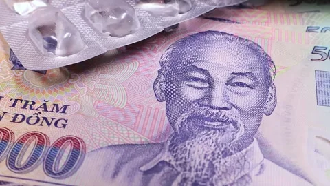 Used empty pill blisters over new sample of five hundred vietnamese dong bills. Stock Footage 294595049
