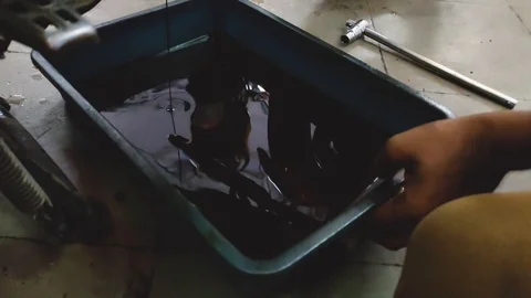 Used engine oil, closeup short of used oil, used oil remove from bike, Stock Footage 118762418