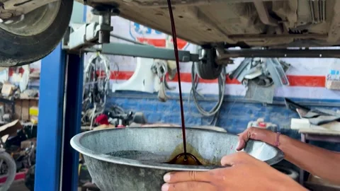 Used Engine Oil Draining From Car During Professional Automotive Oil Change Stock Footage 340955175