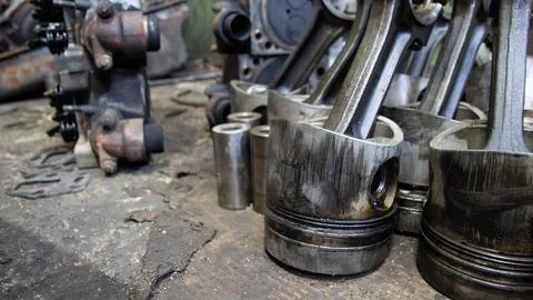 Used engine pistons in a car workshop - close-up Stock Photos