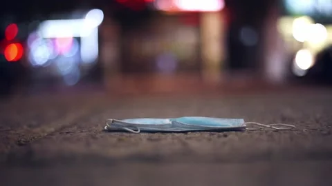 Used face mask thrown away on the street. Stock Footage 139231933
