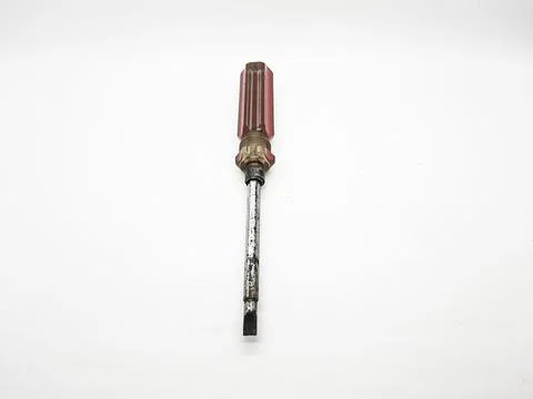 Used flathead screwdriver with red handle on a clean white background Stock Photos