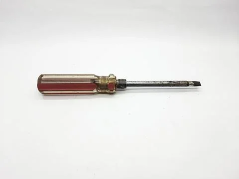 Used flathead screwdriver with a red handle on a clean white background Stock Photos