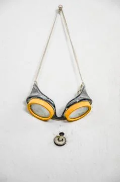 An used goggle hanged on wall Stock Photos