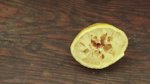 Used half lemon on vitage old wood Stock Footage 80350887