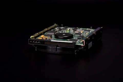 Used hard disk isolated on black background. Dusty old hdd. Stock Photos