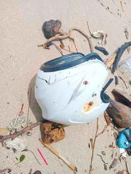 Used helmets thrown on the beach Stock Photos