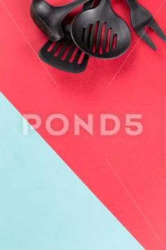 Used home kitchenware with scratches on red paper background Stock Photos