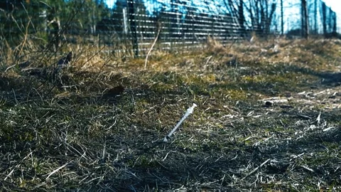 Used Hypodermic Needle Syringe on the Ground Stock Footage 335224070