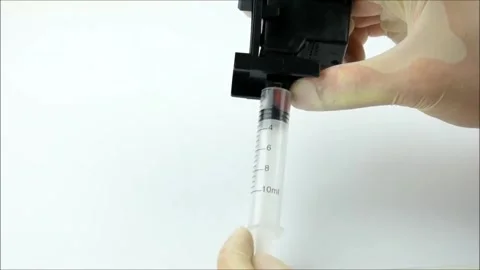 Used Ink Removal: Syringe Pulls Ink from Old Cartridge Stock-Footage 319981104