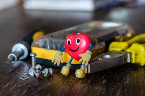 Used Keychain in the shape of a heart on a table. Stock Photos