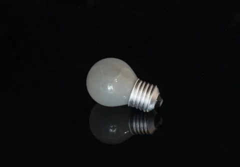 Used light bulb on the dark background Stock Photos