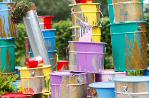 The used paint cans. Many multi-colored buckets with traces of paint on them Stock Photos