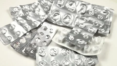 Used pill pack blisters are on a white table, top view Stock Footage 315657204
