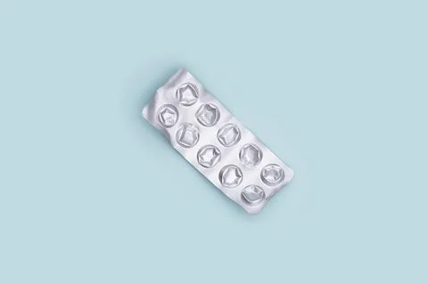 Used pill packaging on a blue background. Stock Photos