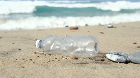 Used Plastic bottle discarded on sea shore ecosystem,environment waste pollution Stock Footage 217411291