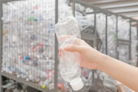 Used plastic bottle in hand Fotos de archivo