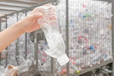 Used plastic bottle in hand Stock Photos