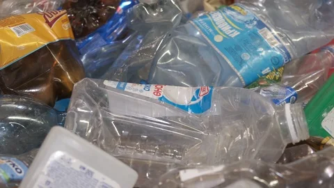 Used plastic bottles moving on the conveyor belt at the factory Stock Footage 107393556