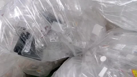Used plastic boxes are bundled and sealed in large plastic bags. Stock Footage 288186975