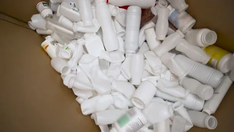 Used plastic caps and packaging of bottles from medicines and tablets are sorted Stock Footage 168053223