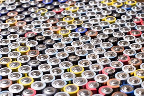 Used in several rows arranged AAA batteries of different colors and manufactu Stock Photos