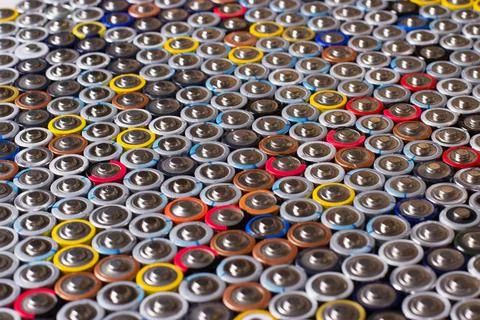 Used in several rows arranged AAA batteries of different colors and manufactu Stock Photos