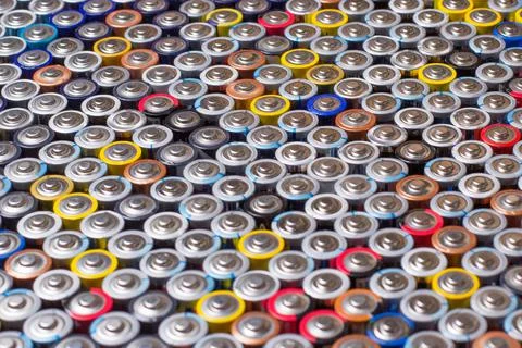 Used in several rows arranged AAA batteries of different colors and manufactu Stock Photos