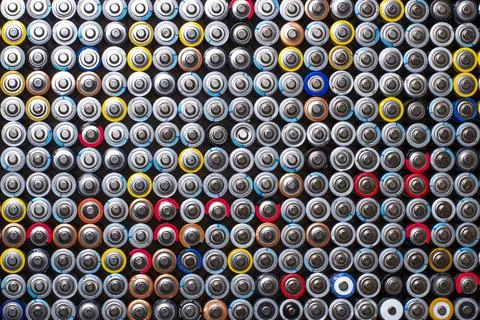 Used in several rows arranged AAA batteries of different colors and manufactu Stock Photos