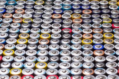 Used in several rows arranged AAA batteries of different colors and manufactu Stock Photos