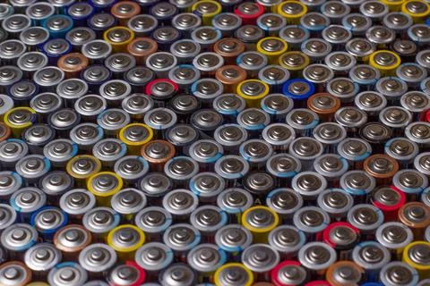 Used in several rows arranged AAA batteries of different colors and manufactu Stock Photos