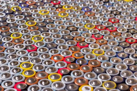 Used in several rows arranged AAA batteries of different colors and manufactu Stock Photos