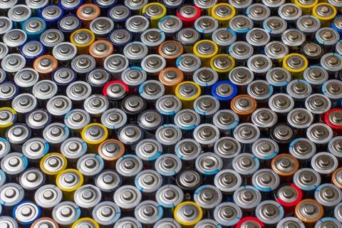 Used in several rows arranged AAA batteries of different colors and manufactu Stock Photos
