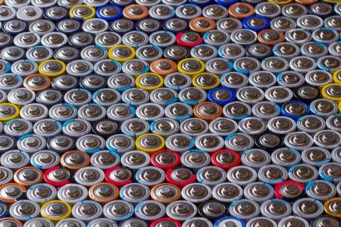 Used in several rows arranged AAA batteries of different colors and manufactu Stock Photos
