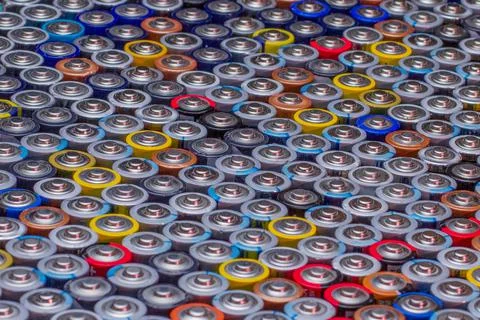 Used in several rows arranged AAA batteries of different colors and manufactu Stock Photos