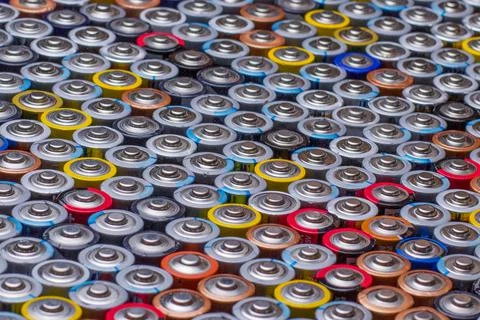 Used in several rows arranged AAA batteries of different colors and manufactu Stock Photos
