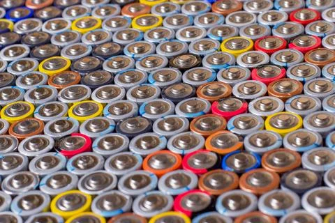 Used in several rows arranged AAA batteries of different colors and manufactu Stock Photos