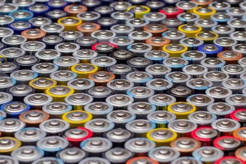 Used in several rows arranged AAA batteries of different colors and manufactu Stock Photos