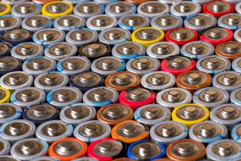 Used in several rows arranged AAA batteries of different colors and manufactu Stock Photos
