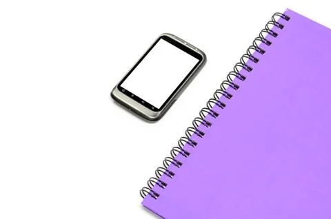 Used smartphone with grey note book Stock Photos