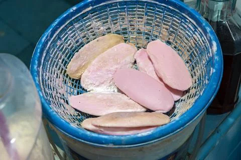 Used soaps lie in plastic baskets on the edge of the water tank in the bathroom Stock Photos
