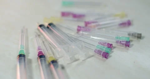 Used syringes are ready to be discarded.Used syringes must be thrown away. Stock Footage 294700730